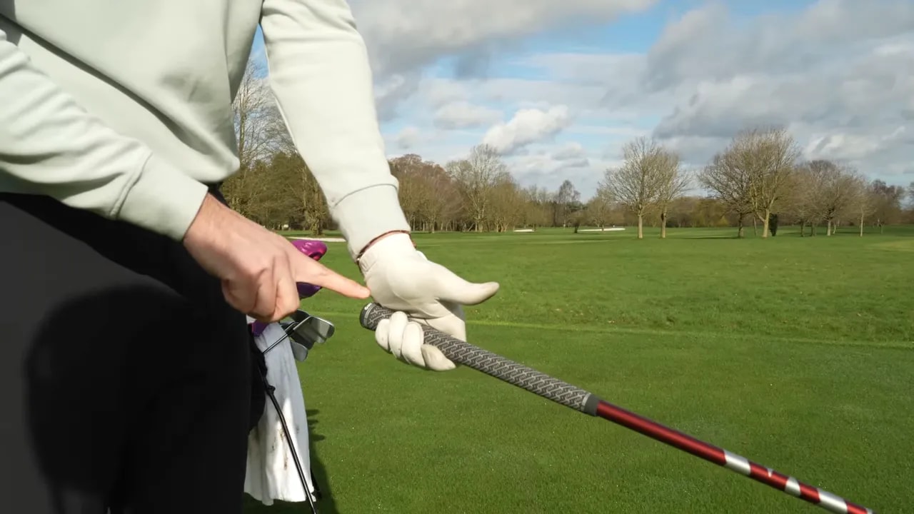 Golfer demonstrating hand and club position while raising the club near parallel