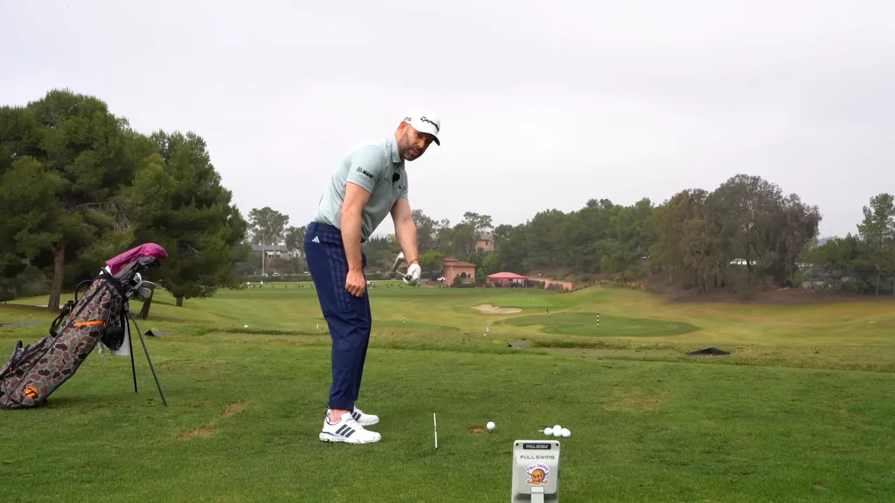 Golfer at iron address setup preparing for clubface twist and compression drill