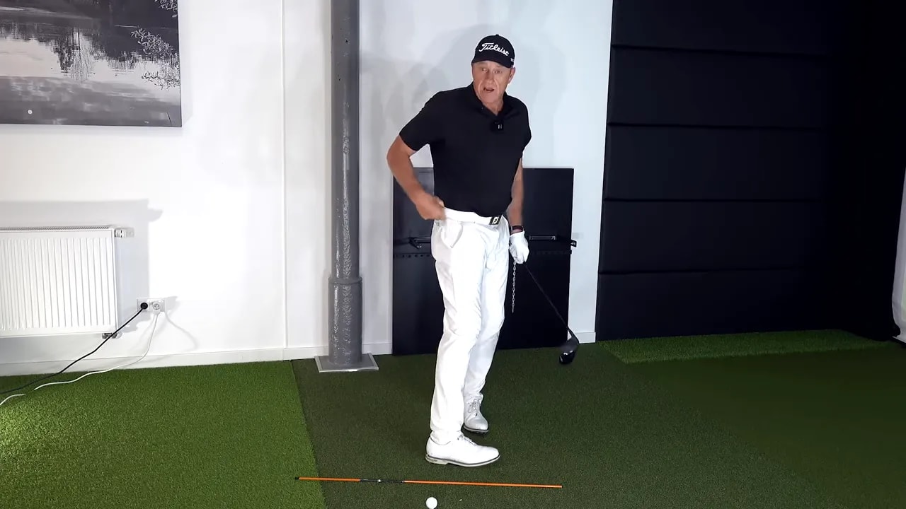 Golfer demonstrating Rory McIlroy right-eye lowering and shortening the right side to shallow the club in the downswing