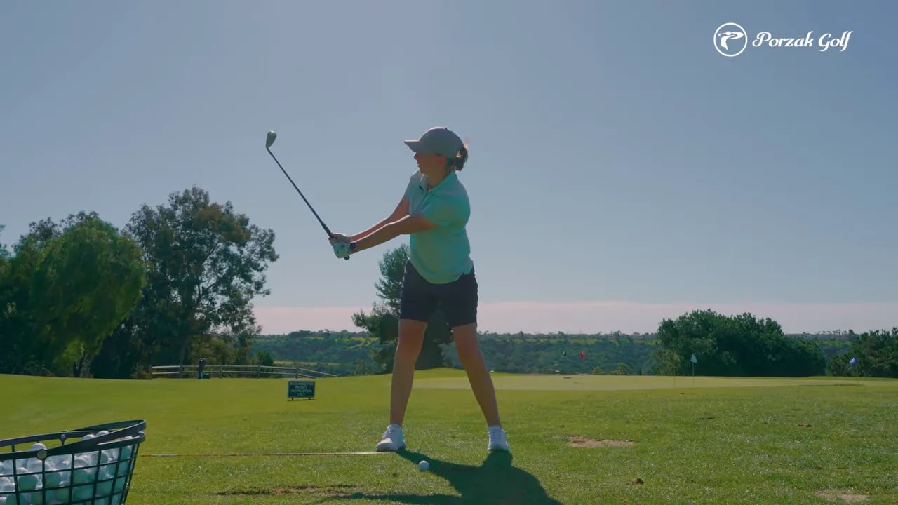 Golfer demonstrating takeaway to transition position on the practice range