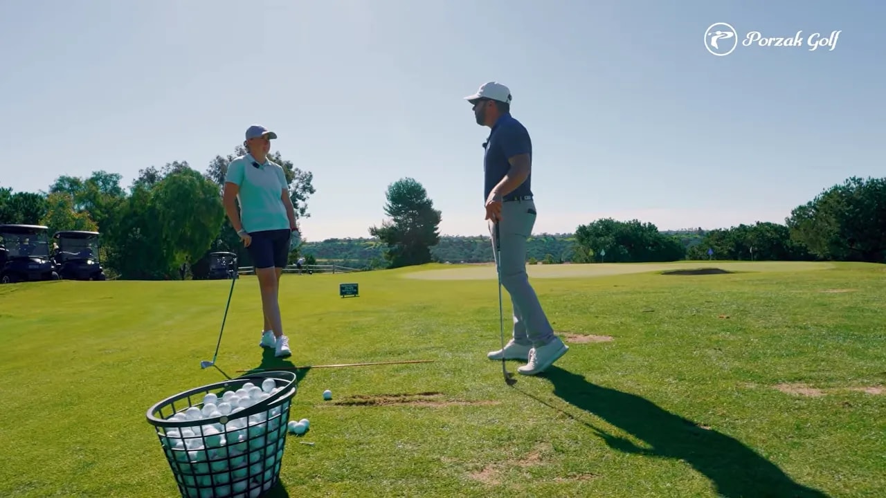 Golfer on a golf range with a ball basket and alignment line context for takeaway troubleshooting