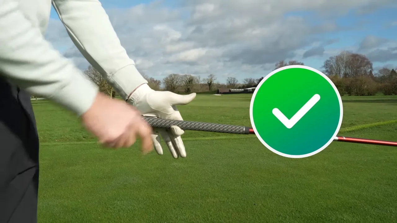 Close-up of golfer grip security test with checkmark callout showing index-finger and pad contact