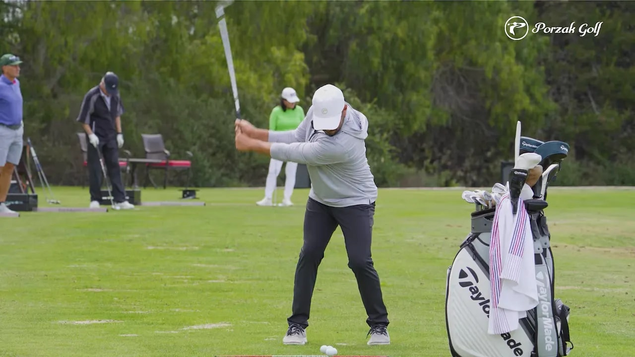 Golfer in halfway-back position with wrists set for an effortless swing