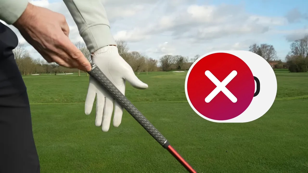 Close-up of golfer grip placement with incorrect X marker