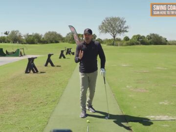 Instructor explaining hips-forward downswing concept on a golf practice range