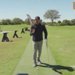 Instructor explaining hips-forward downswing concept on a golf practice range