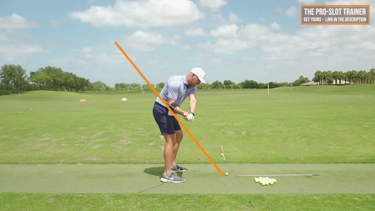 Golf swing image with orange marker highlighting the right elbow position and arm action