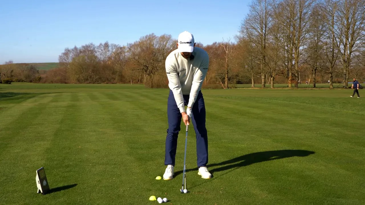 Golfer at address demonstrating a stable, pressure-driven golf swing setup on the fairway
