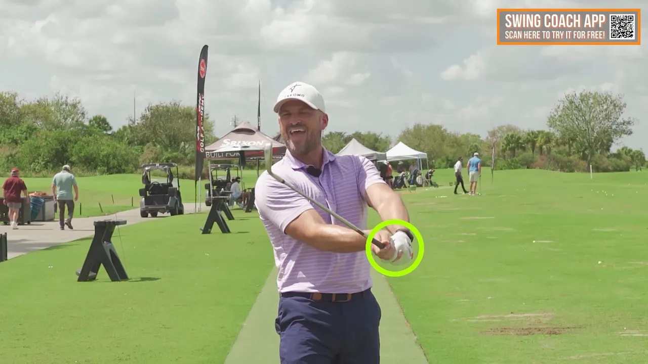Golf instructor showing right wrist forward and hands ahead impact feel on the practice range