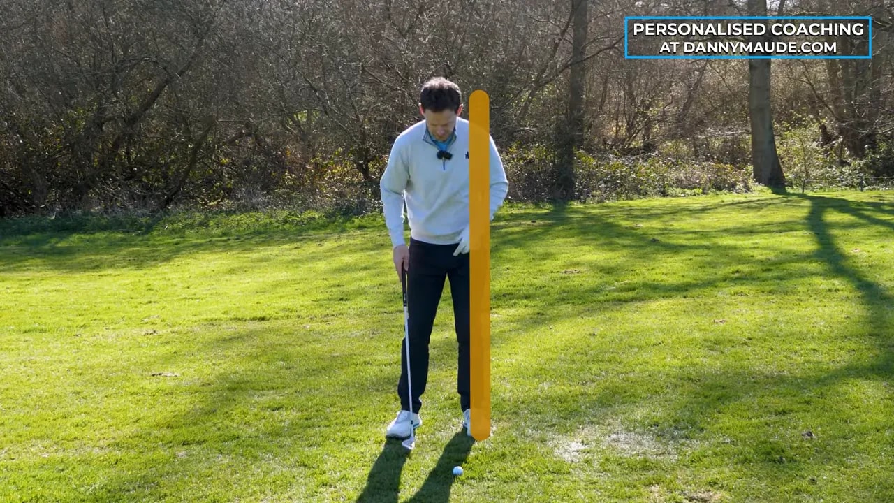 Coach demonstrating Step 1 stacked pitch delivery with alignment aid