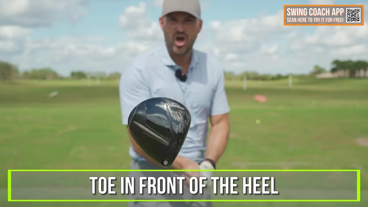 On-screen text cue showing toe in front of the heel while the coach demonstrates squaring the driver face