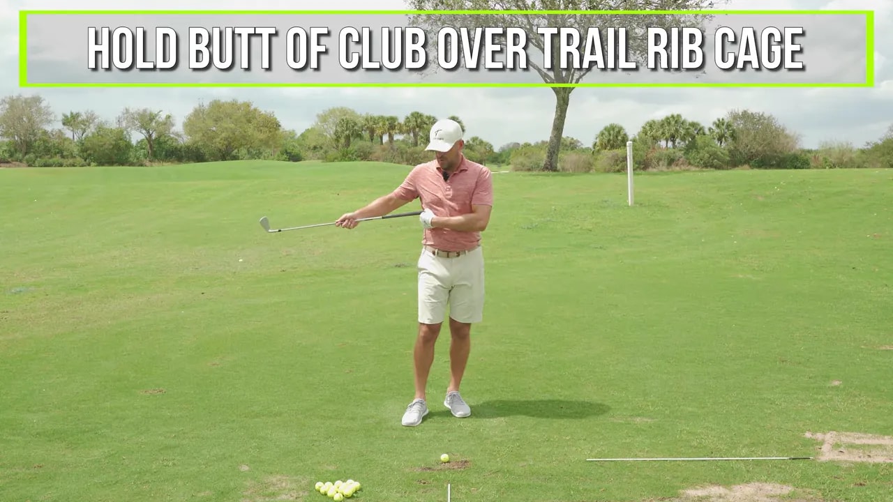 Drill setup for trail side down: butt end of club held over the trail rib cage