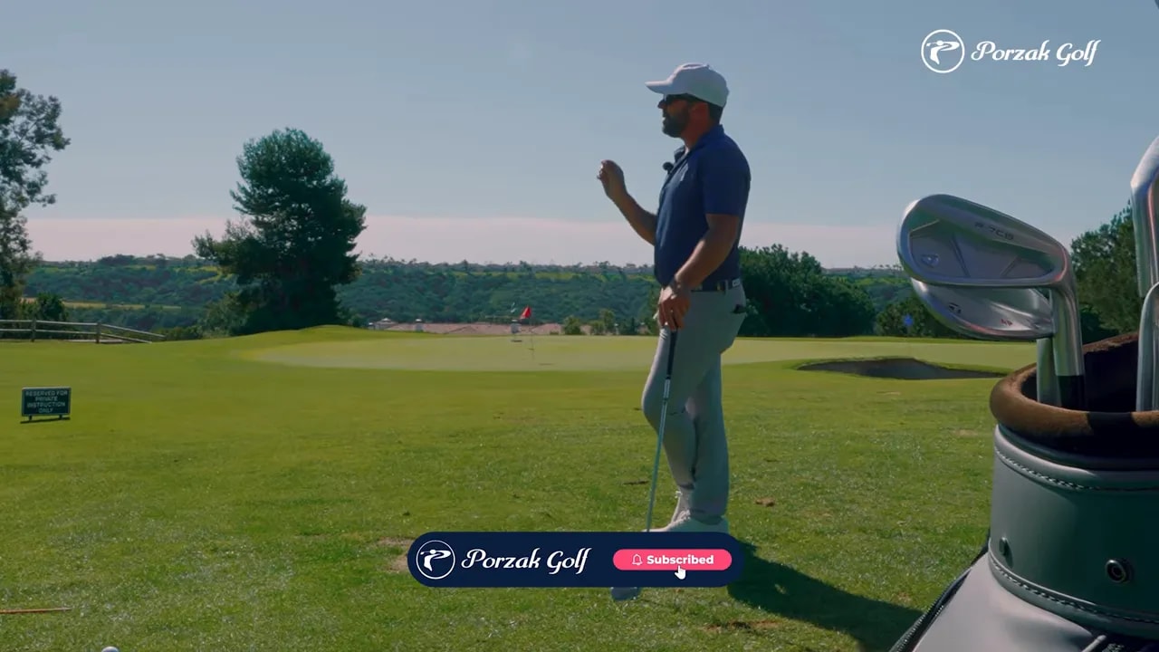 Golfer practicing a transition checkpoint on the range with club and hands positioned for improved sequencing