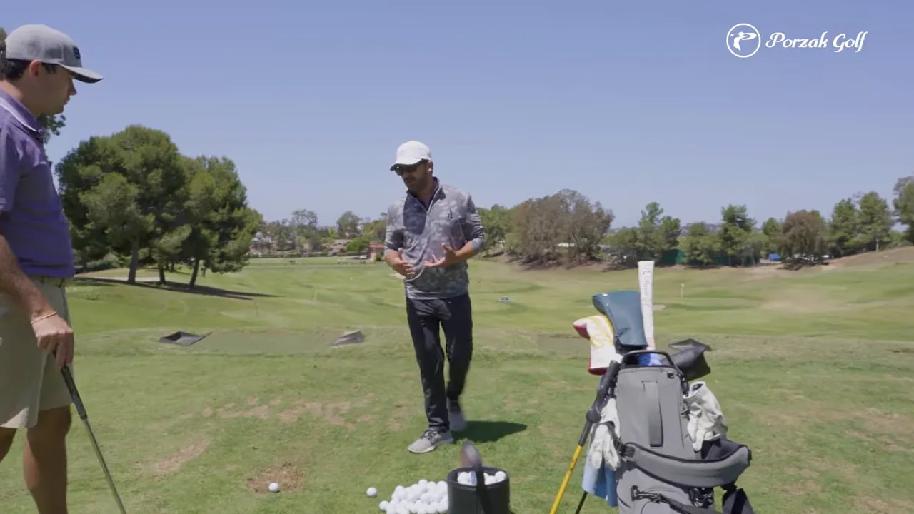 Golfer demonstrating address setup and posture on a sunny practice range to start a connected swing