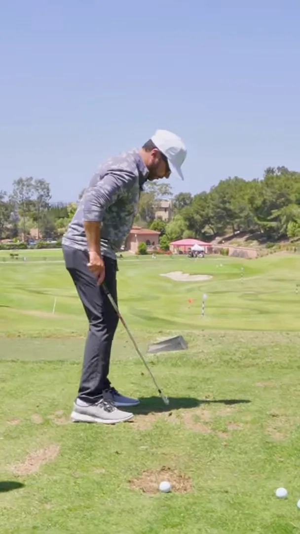 Golfer demonstrating checkpoint one with club parallel to the ground on the takeaway