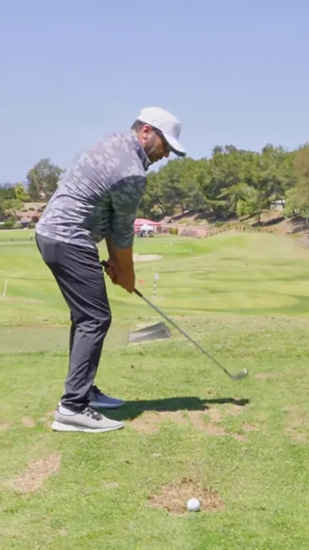 Golfer demonstrating a checkpoint one style position with the club moving in a consistent backswing route