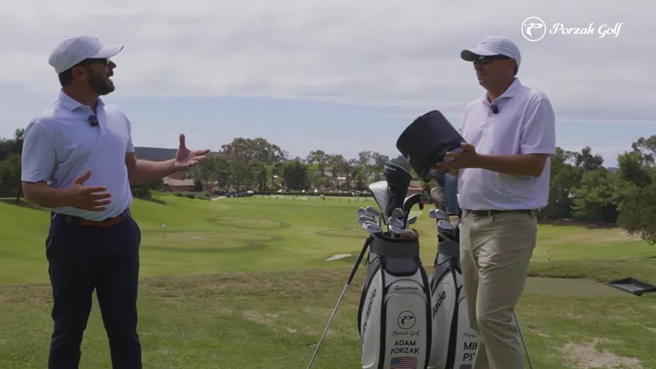 Instructor and golfer discussing connected core-driven movement for wedge compression