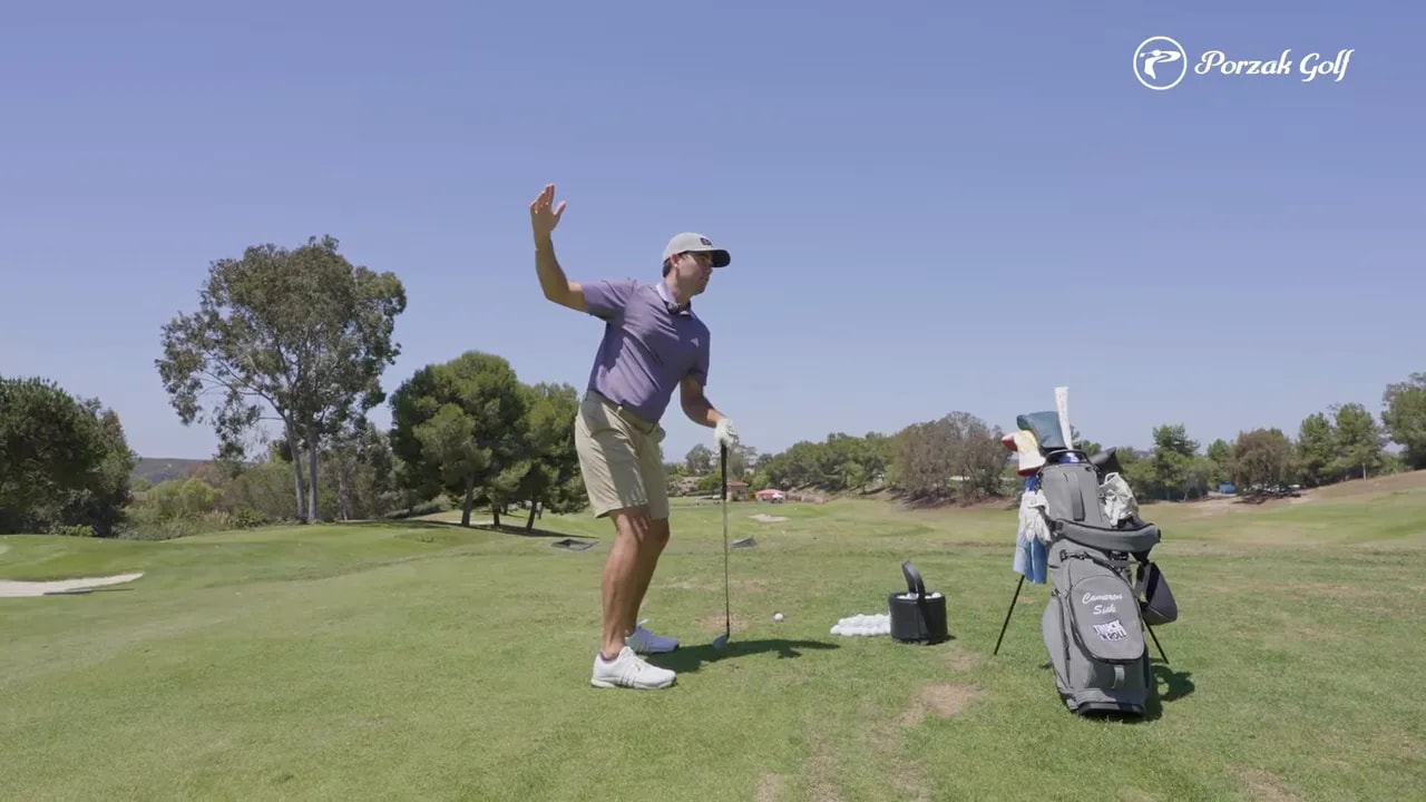 Golfer demonstrating a connected downswing position with arms and body moving together