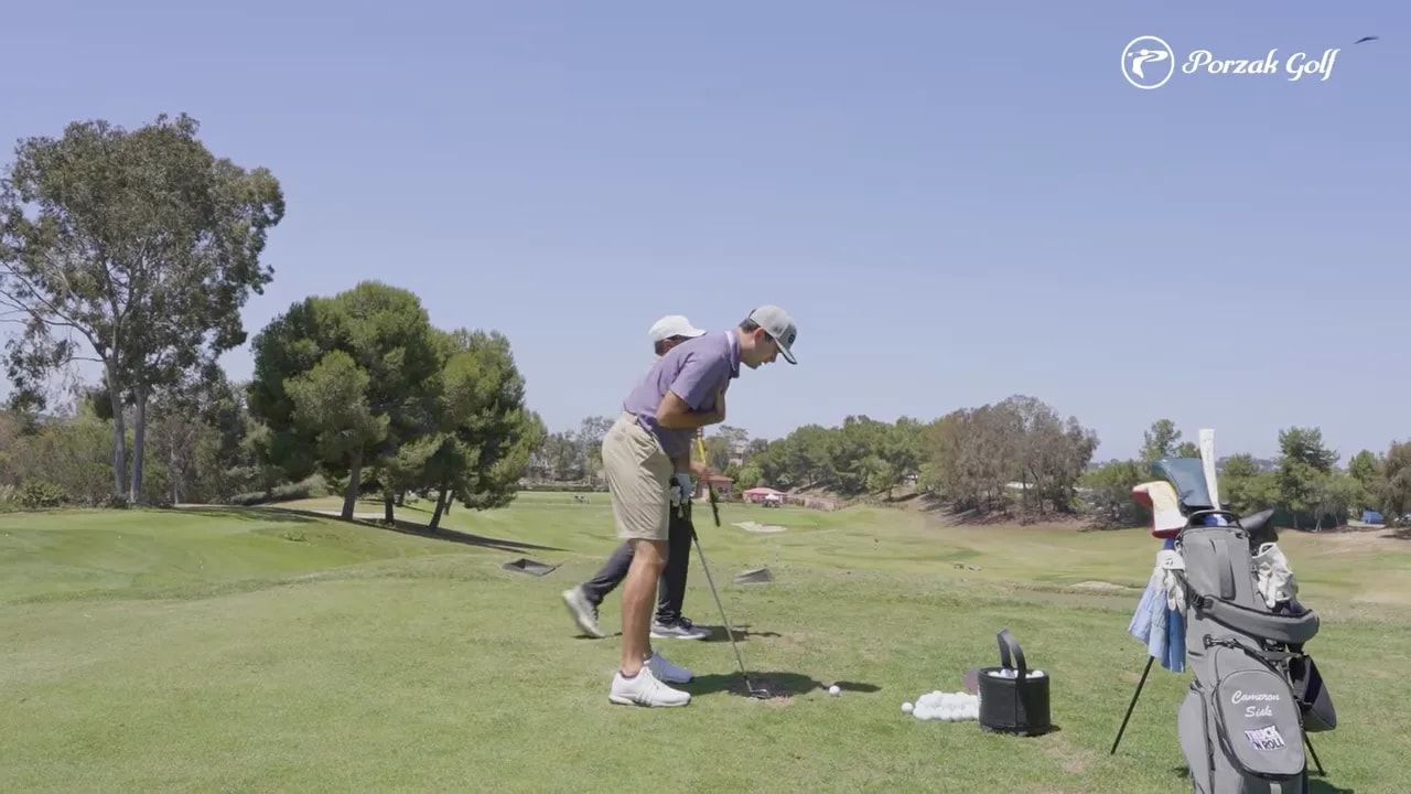 Golf instructor showing connected downswing mechanics during iron setup and practice