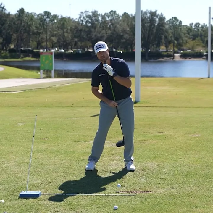 Golfer demonstrating spine tilt away from target at driver address