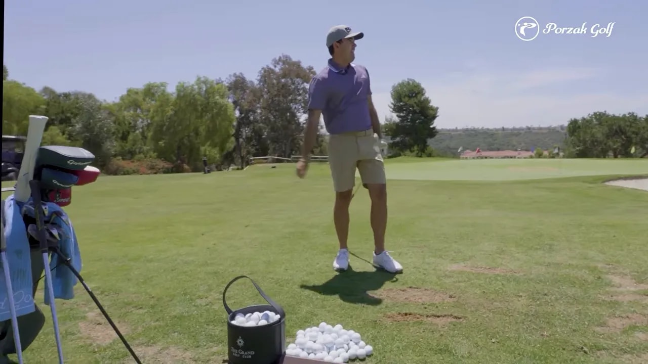 Golfer practicing iron shots on a range with clubs and balls ready for trajectory work