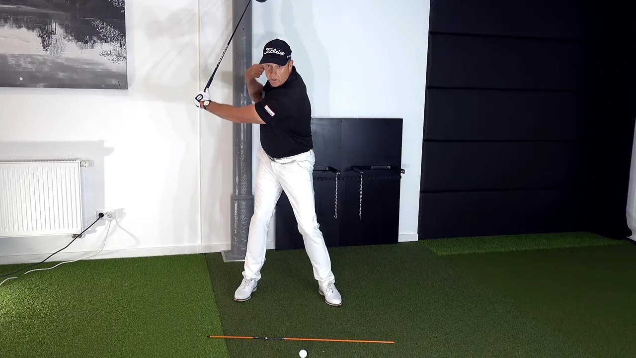 Golf swing drill showing the right side lowering into the downswing