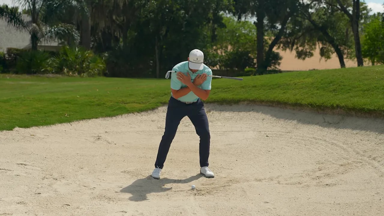 Golfer demonstrating neutral shoulders and spine tilt for better contact in greenside bunker play