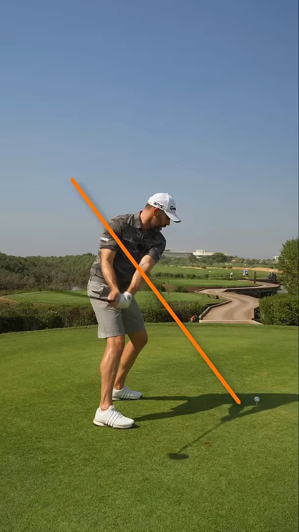 Golfer demonstrating the hands-dropping-behind-you sequence for an inside club approach