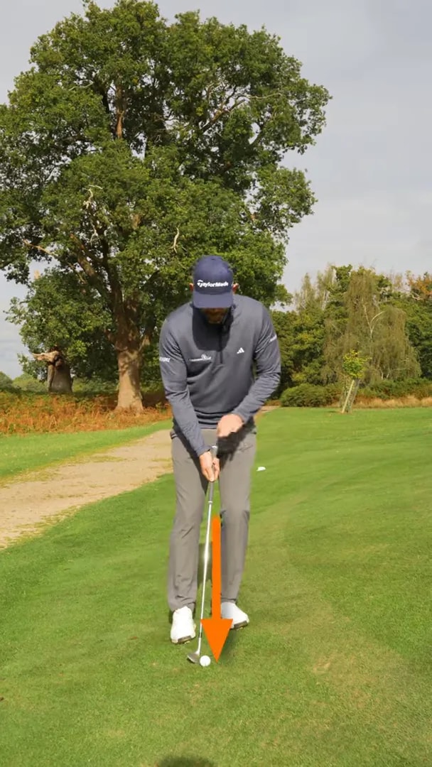 Golfer demonstrating a lower, more driven upslope chip setup with adjusted ball position and wedge