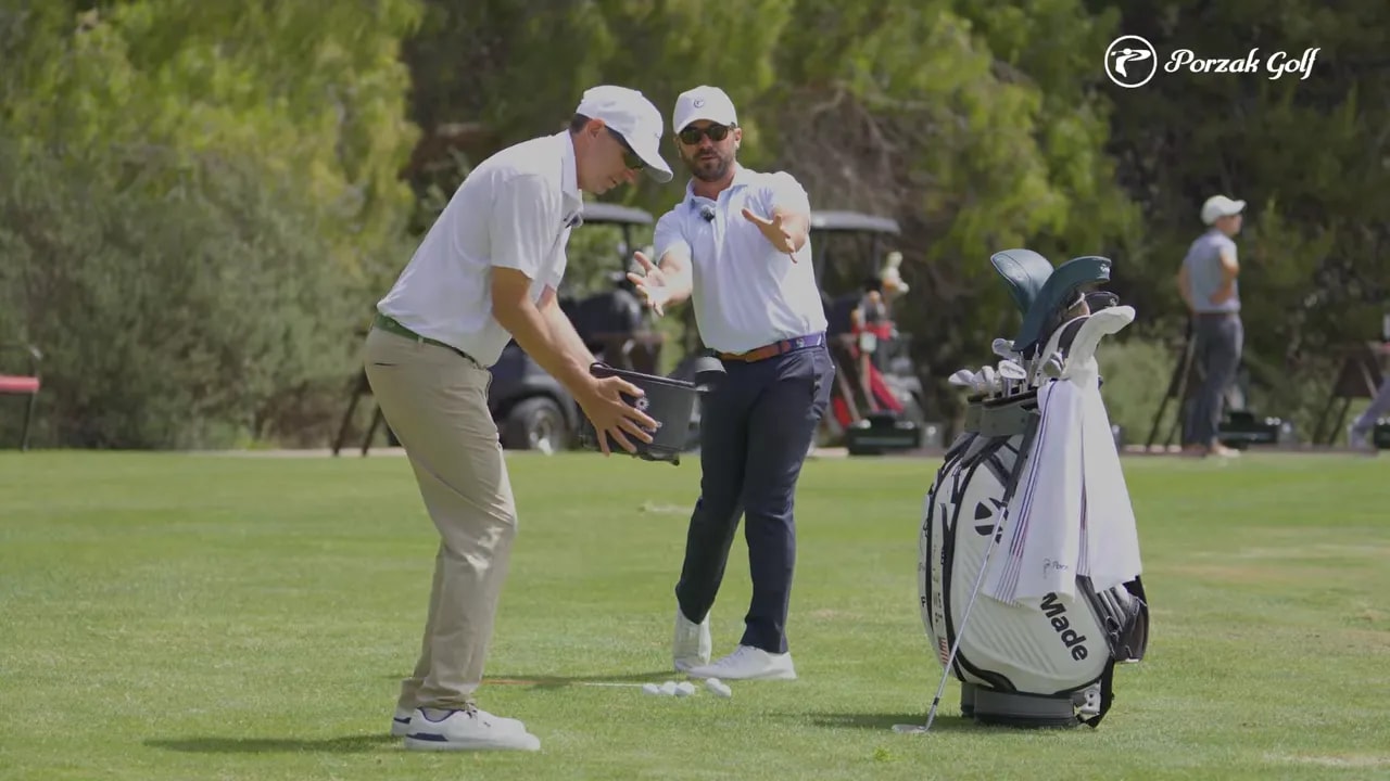 Coach and golfer demonstrating the connected medicine ball feel for wedge compression