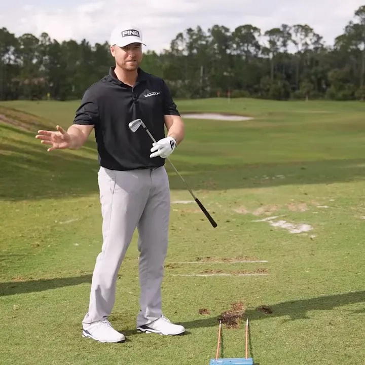 Golfer explaining opposite-shot practice for creating controlled draw and fade ball flights