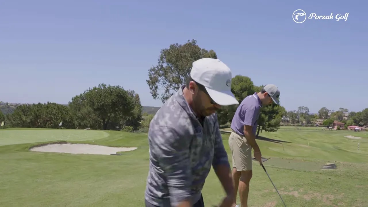 Golfer practicing a connected swing on a sunny golf range with an organized release