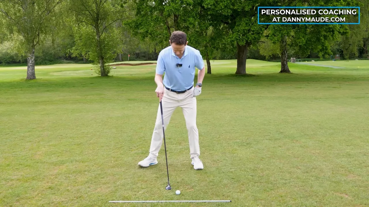 Golfer demonstrating prop drill while keeping head centered for better low-point control