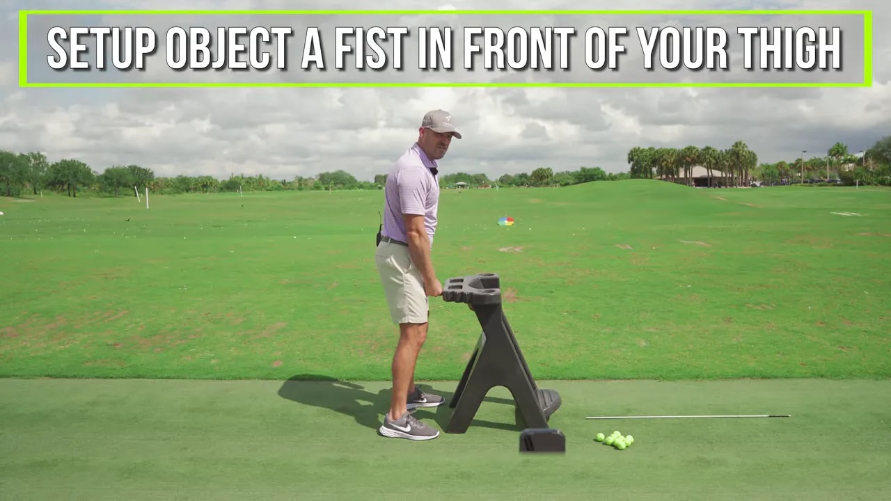 Instruction overlay: set object a fist-width in front of your thigh for trail leg downswing drill