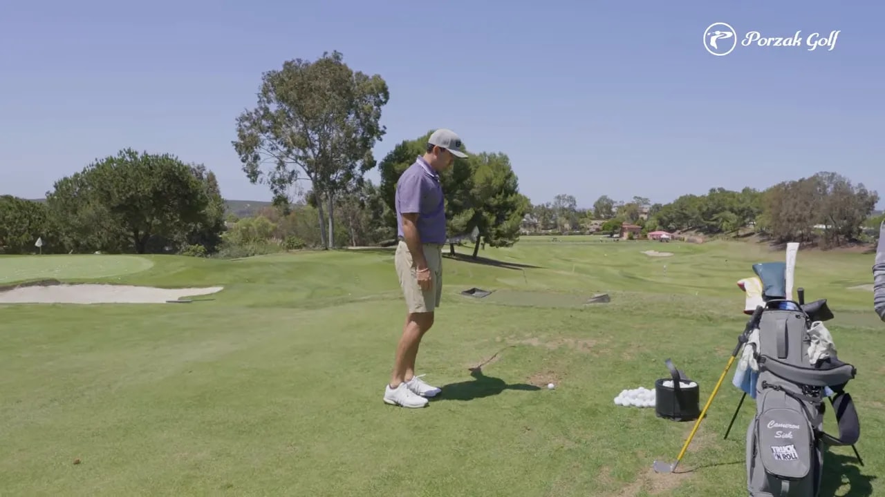 Golfer practicing a three-quarter knockdown drill with repeatable address and club positioning at the range
