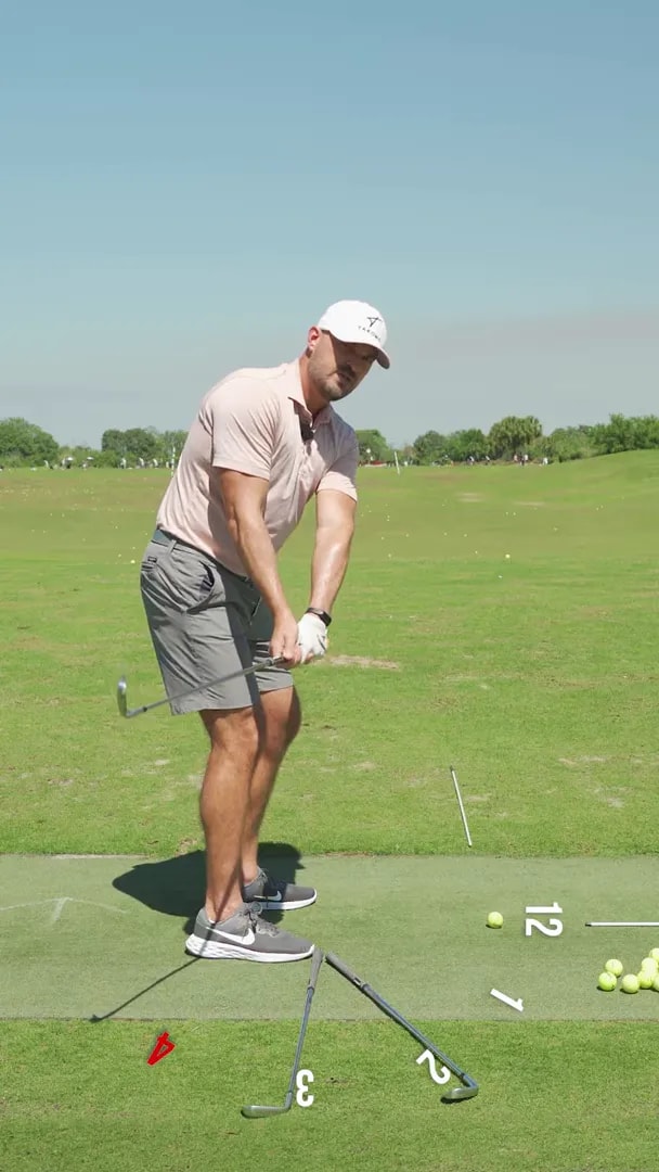 Golf takeaway drill position with focus on earlier wrist hinge and reduced inside arm rotation using clock references