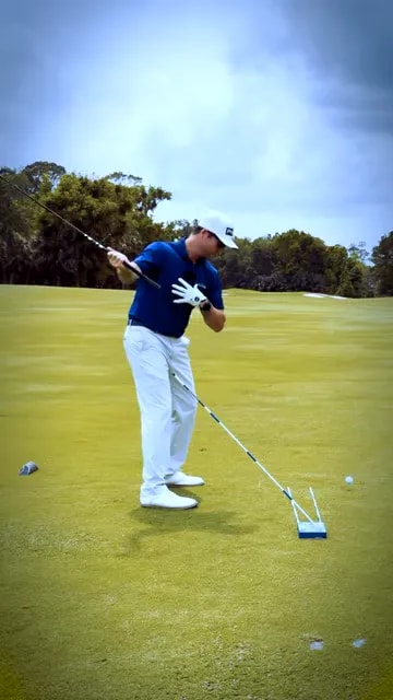 golfer demonstrating upper body covering the ball with club moving in front through downswing