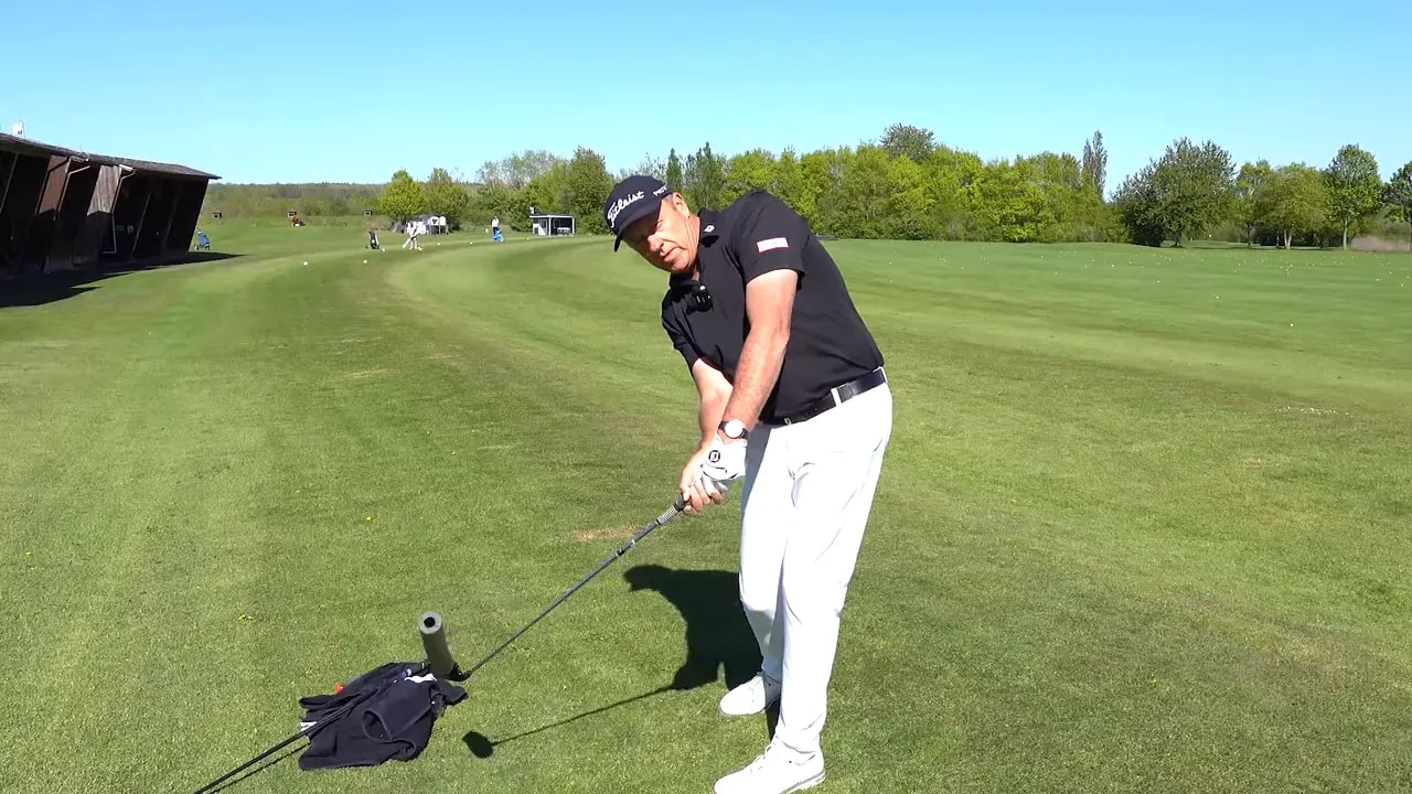 golfer demonstrating release outdoors with large text driver vs iron