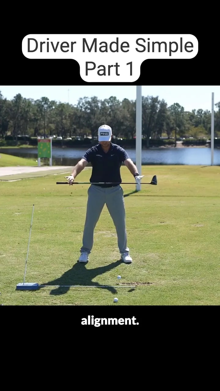 golfer holding a club across the body near an alignment stick on the ground
