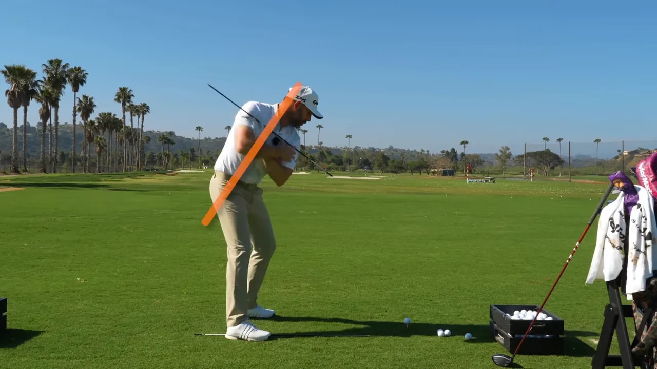 Side view of golfer demonstrating backswing tilt with orange lines along the body and club