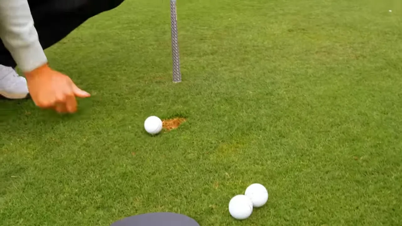 close up of golf ball position and divot mark on grass after strike