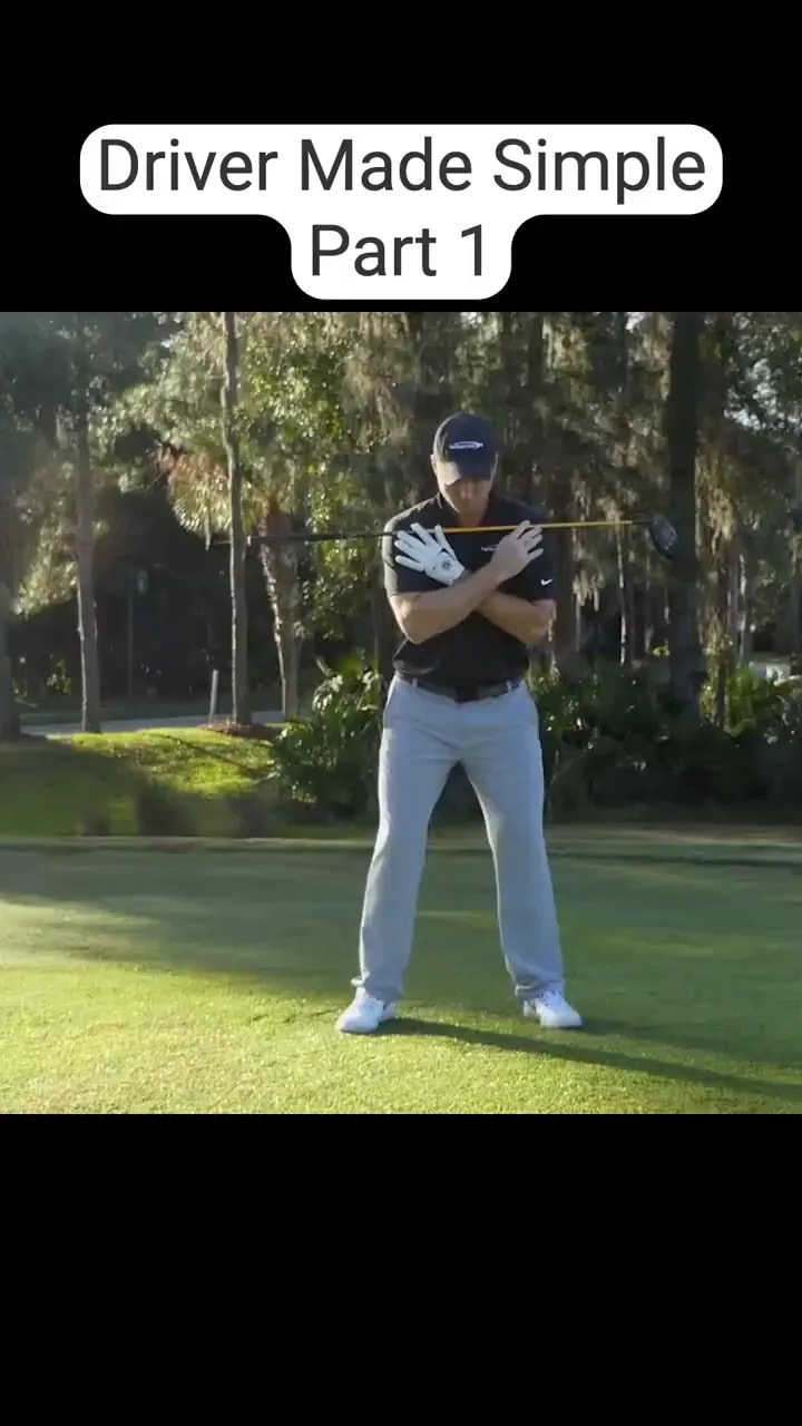 golfer standing on grass with club across shoulders in a wide stance