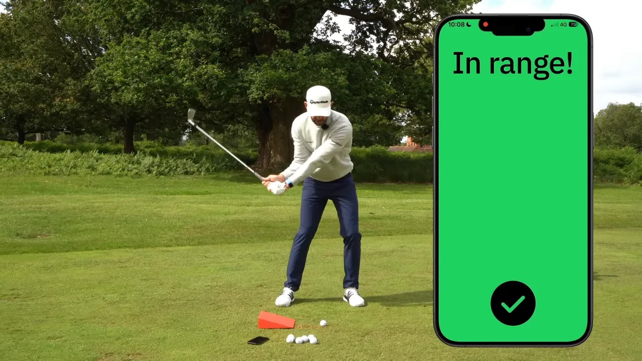 phone screen showing in range beside golfer in delivery position