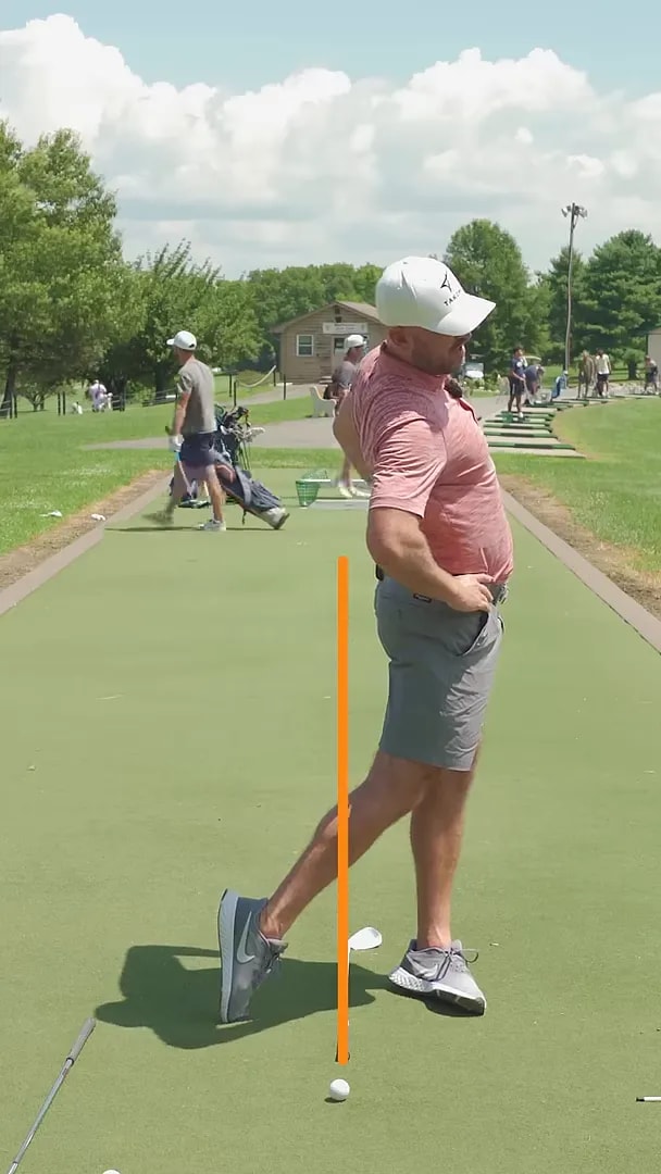 side view of golfer with hips pushed forward past an orange vertical line and chest tilted back