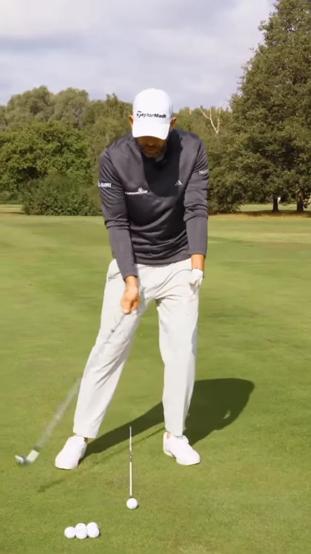 Golfer at address next to a launch monitor display showing minus 4.7 and full swing