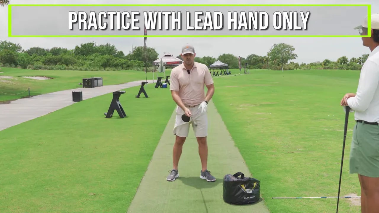 Golfer preparing a drill with on screen text that says practice with lead hand only