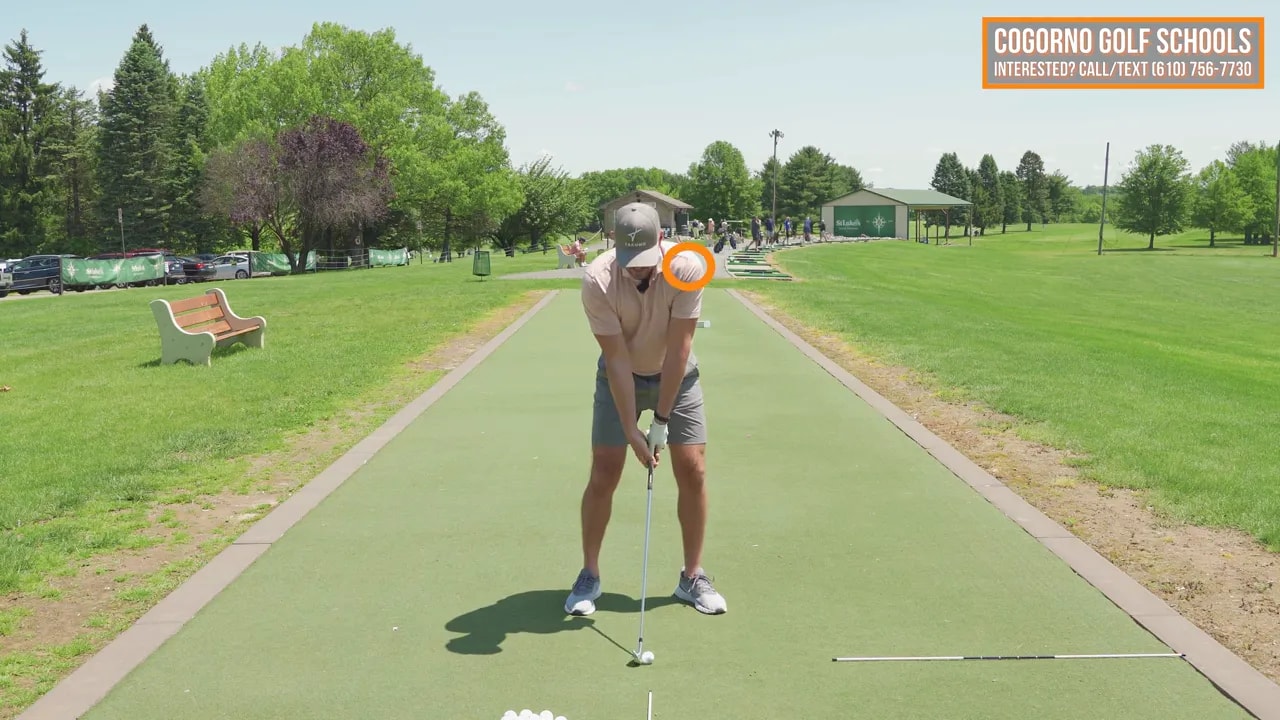 Front view of golfer at address with highlighted lead shoulder and text lead shoulder down