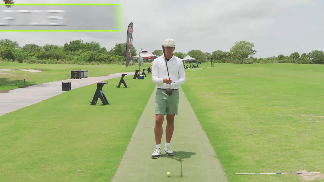Golfer holding club upside down with on screen text that says make the club whoosh