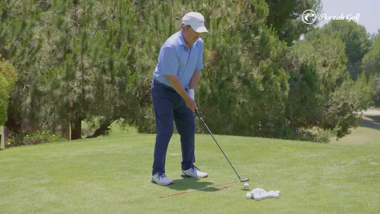 golfer at address position over the ball on the fairway