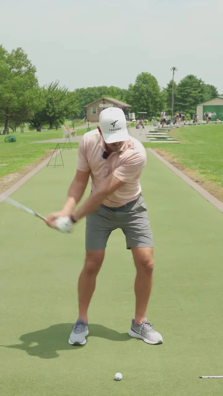 Golfer at impact area with arms extended and club moving through the ball